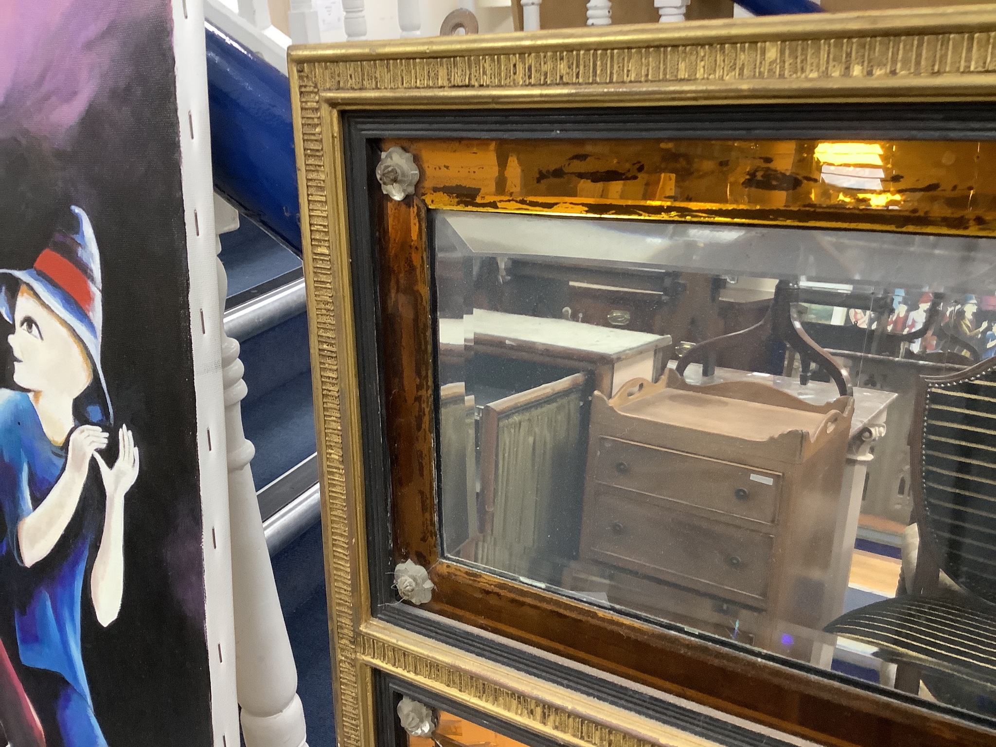 An 18th century moulded gilt overmantel, three mirror plates and amber glass borders and clear glass rosettes